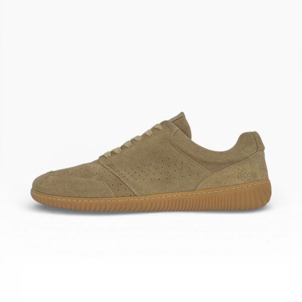 Side profile of a barefoot beige suede shoe