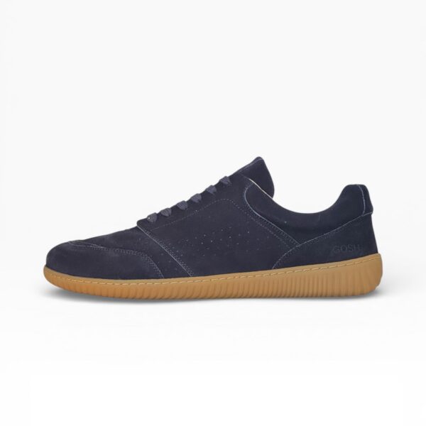 Side profile of a barefoot navy blue suede shoe